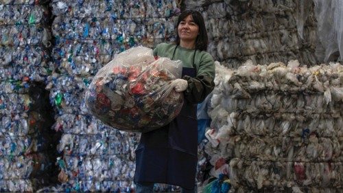 epa09833130 Turkish artist Deniz Sagdic poses with a bag of soft drink box wastes during her waste ...