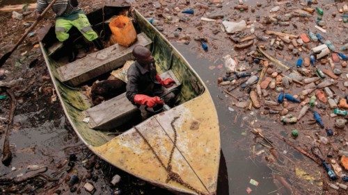 Two workers from the Ruzizi I hydroelectric plant take an inspection tour of the Ruzizi River to see ...