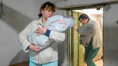 TOPSHOT - Nurses carry babies to the basement of maternity hospital as sirens warning for air raids ...