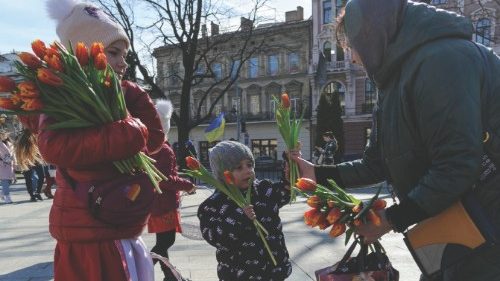 epa09853368 Ukrainian children sell flowers during their action called 'Buy flowers and support our ...