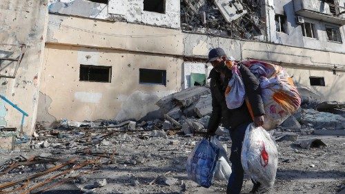 Local resident and shoemaker Gennady, who didn't give his full name, transports belongings from his ...