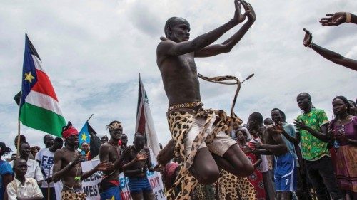 People celebrate as they wait for the arrival of South Sudan's President Salva Kiir in the capital ...