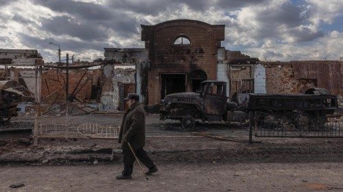 epa09859966 A man walks past destroyed Russian military vehicles next to the railway station where ...