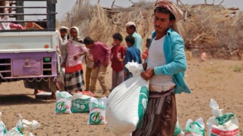 Yemenis displaced by the conflict, receive food aid and supplies to meet their basic needs, at a ...