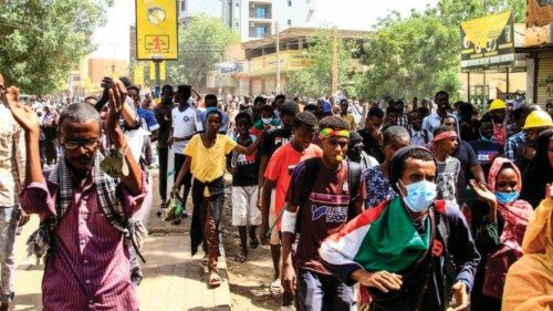 Sudanese demonstrators take to the streets of the capital Khartoum to protest last year's military ...
