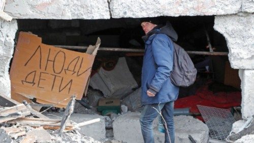 A man walks outside a building damaged in the course of Ukraine-Russia conflict in the southern port ...