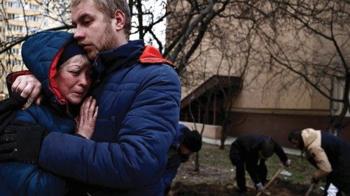 Serhii Lahovskyi, 26, hugs Ludmyla Verginska, 51, as they mourn their common friend  Ihor ...