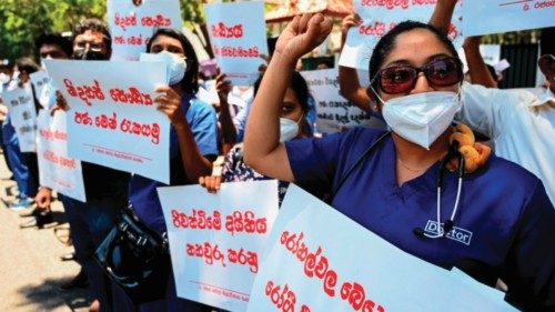 Members of the Government Medical Officers' Association hold placards during a silent demonstration ...