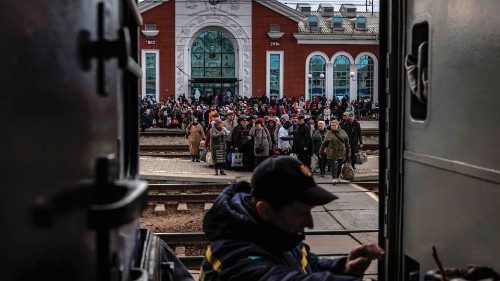 Families wait to board a train at Kramatorsk central station as they flee the eastern city of ...
