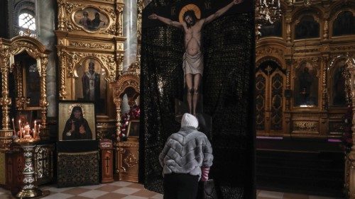 epa09852769 A Ukrainian woman prays inside the St. Elijahs Monastery during the Sunday service in ...