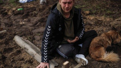 Serhii Lahovskyi, 26, mourns next to the grave of his friend Ihor Lytvynenko, who according to ... Serhii Lahovskyi, 26, mourns next to the grave of his friend Ihor Lytvynenko, who according to ...