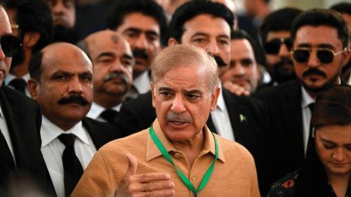 Pakistan's opposition leader Shehbaz Sharif (C) speaks with the media before attending a hearing ...