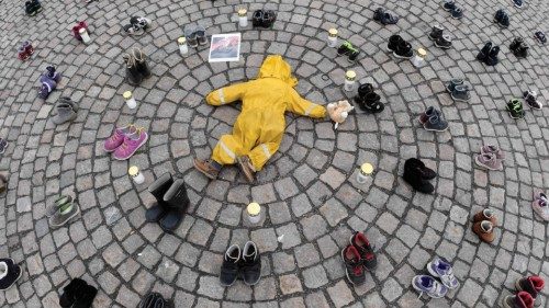 TOPSHOT - Candles, a children's clothing and shoes are seen during a demonstration organized by the ...