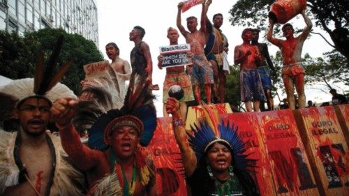 Indigenous people perform 'Ouro de Sangue' (Blood Gold)' in front of Ministry of Mines and Energy as ...