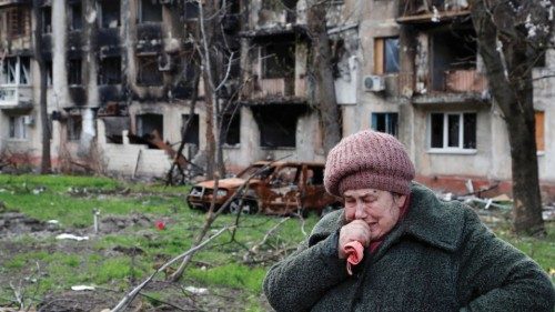 Local resident Tamara, 71, cries in front of an apartment building destroyed during Ukraine-Russia ...