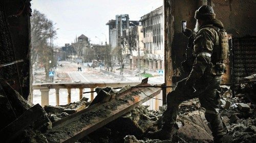 TOPSHOT - A Russian soldier patrols at the Mariupol drama theatre, hit last March 16 by an ...