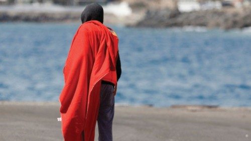 A migrant walks to a Red Cross tent after arriving on a Spanish coast guard boat vessel, in the port ...