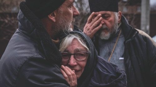 Relatives of a civilian man exhumed from his yard react in Gostomel village, Kyiv region on April ...