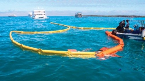 Rangers place absorbent material where a boat sank on April 23, 2022 near Puerto Ayora in Santa Cruz ...