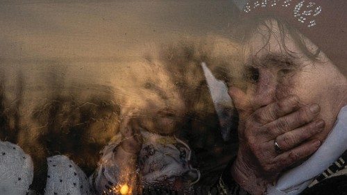 epa09849862 A woman sits with a baby on a bus as they with other people who fled from the besieged ...