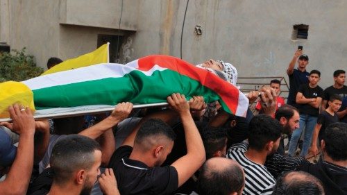 Palestinians carry the body of Ahmed Ibrahim Oweidat, who was killed during an Israeli forces ...