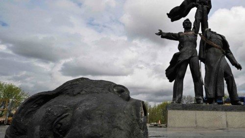 Workers dismantle the Soviet monument to Ukraine-Russia friendship in Kyiv on April 26, 2022, amid ...