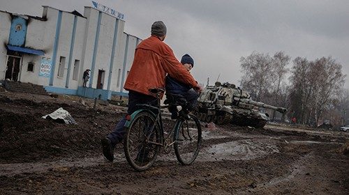 A man pushed a bike in the demolished town center of Trostyanets after Ukrainian forces expelled ...