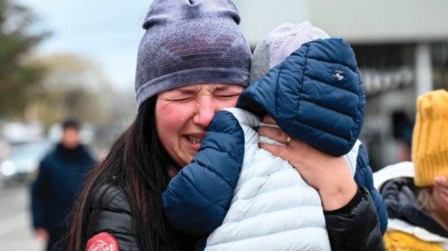 A Ukrainian refugee holding her child cries as she arrive at the Siret border crossing between ...