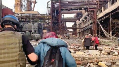 Azov regiment members walk with civilians during UN-led evacuations from the sprawling Azovstal ...