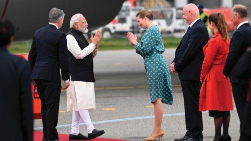 Denmarks Prime Minister Mette Frederiksen (3rd L) greets Indian Prime Minister Narendra Modi (2nd L) ...