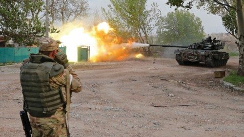 Service members of pro-Russian troops fire from a tank during fighting in Ukraine-Russia conflict ...