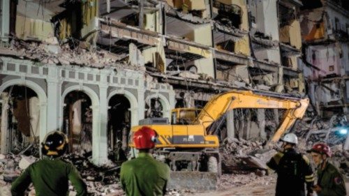 Firefighters and rescue workers remove debris from the ruins of the Saratoga Hotel, in Havana, on ...