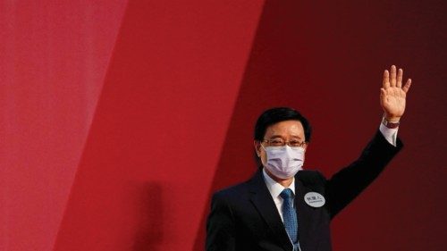 John Lee waves after being elected as Hong Kong's Chief Executive, in Hong Kong, China, May 8, 2022. ...