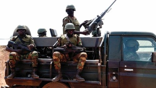 (FILES) In this file photo taken on February 17, 2020 Togolese soldiers stand guard as they patrol ...