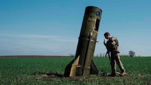 TOPSHOT - A Ukrainian serviceman looks at a Russian ballistic missile's booster stage that fell in a ...