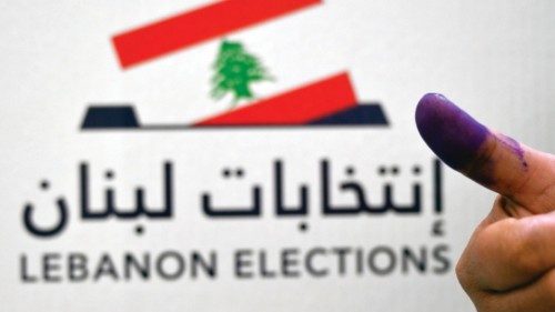 epa09941981 A Lebanese Government employee shows his ink-stained finger after casting his vote for ...
