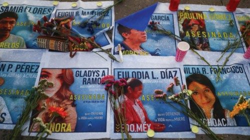 Flowers are placed on the images of murdered environmentalists during a protest on Earth Day to ...