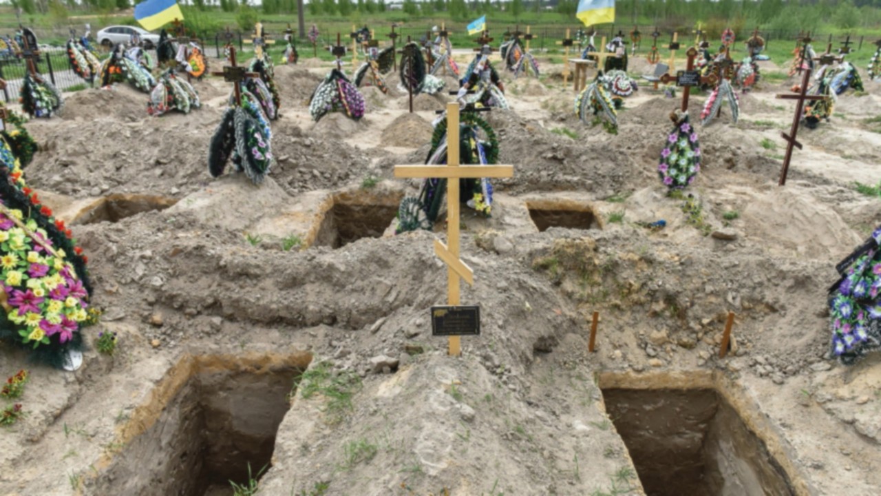 epa09949872 New graves at the municipal cemetry of Bucha in the city of Kyiv (Kiev) area, Ukraine, ...