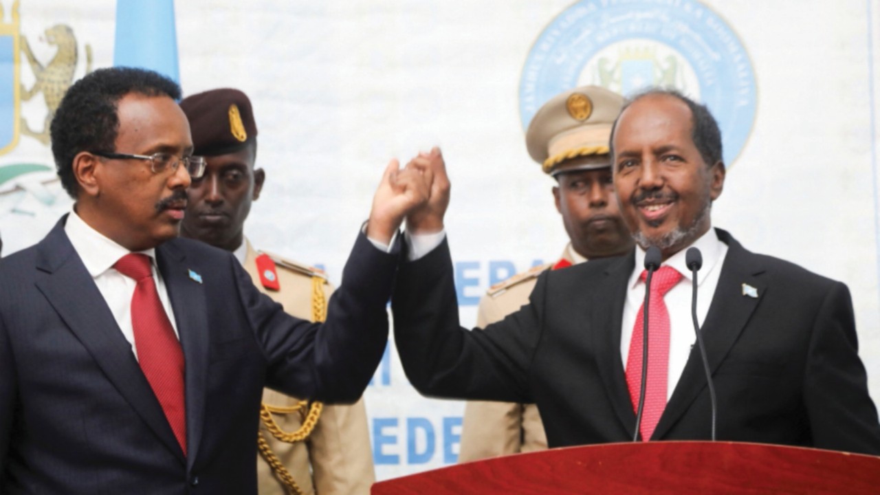 Hassan Sheikh Mohamud(R), Somalia's newly elected president hold hands with Mohamed Abdullahi ...