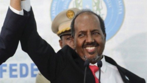Somalia's newly elected president Hassan Sheikh Mohamud holds hands with incumbent president Mohamed ...