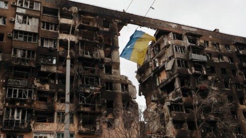 A view shows a torn flag of Ukraine hung on a wire in front an apartment building, which was ...