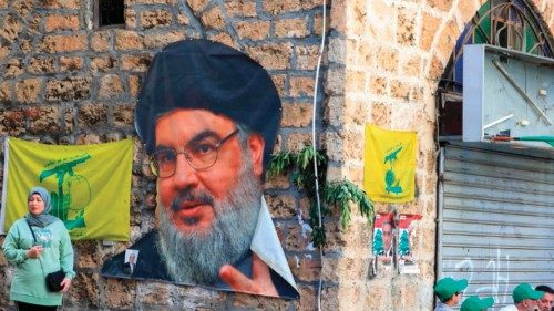 Electoral delegates for Lebanon's Shiite groups Amal (L) and Hezbollah sit in front of a polling ...