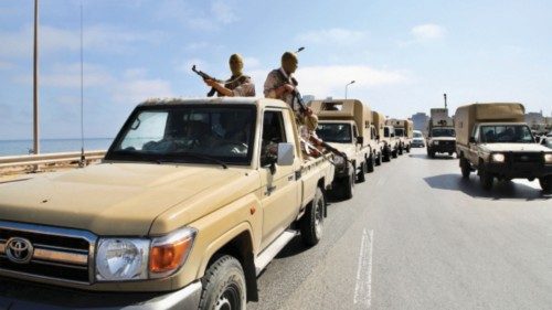 Soldiers loyal to the head of Libya's Government of National Unity, Abdulhamid al-Dbeibah, sit in ...