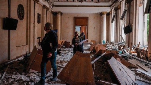 TOPSHOT - Construction engineers examine a damaged building of the Kharkiv Regional State ...