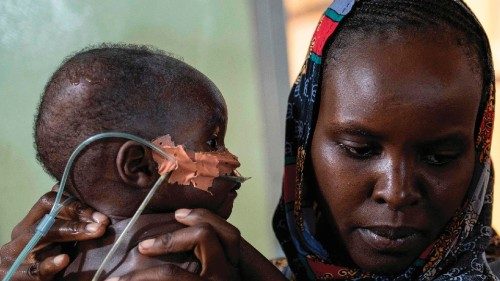 Kartuma Urlaman comforts her malnourished son Imran, in the emergency medial care section for ... Kartuma Urlaman comforts her malnourished son Imran, in the emergency medial care section for ...