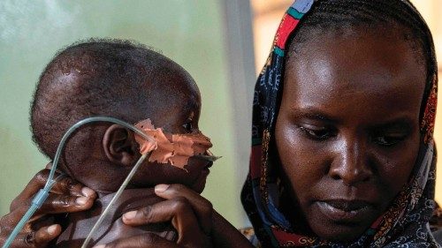 Kartuma Urlaman comforts her malnourished son Imran, in the emergency medial care section for ...