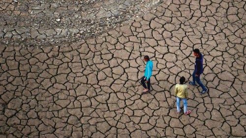TOPSHOT - Youths walk along a dry river bed on the banks of the river Ganges, in Allahabad on ... TOPSHOT - Youths walk along a dry river bed on the banks of the river Ganges, in Allahabad on ...