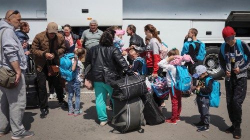 Ukrainian refugees from Mariupol region board a bus bound for Poland, at a registration and ...