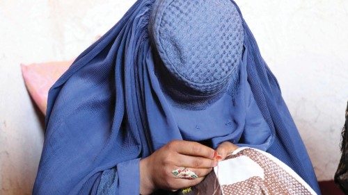 epa09966304 An Afghan woman works on an embroided clothing at a workshop in Kandahar, Afghanistan, ...