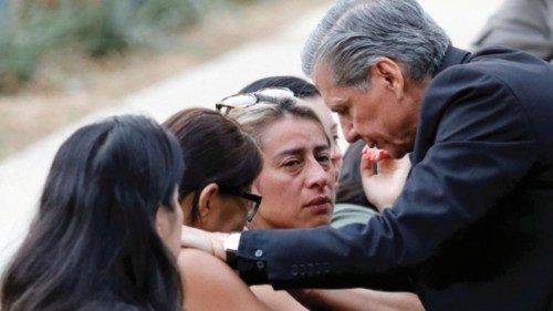 Gustavo Garcia-Siller, Archbishop of the Archdiocese of San Antonio, comforts people as they react ...